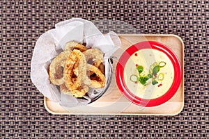 Deep Fried Calamari Rings on backet with Sauce Bowl