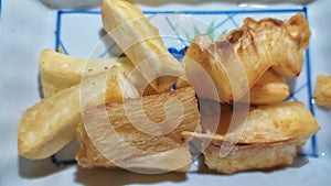 Deep fried cassava root . Brazilian Mandioca Frita (deep fried cassava manioc yuca). Feijoada side dish. photo