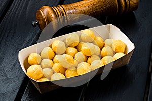 Deep fried cheese and potato balls on the black background photo