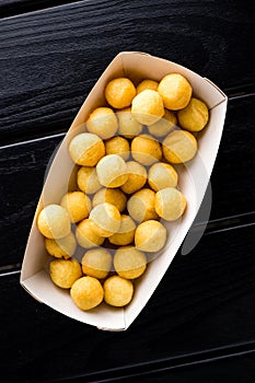 Deep fried cheese and potato balls on the black background photo