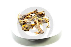 Deep fried chicken bones on white plate