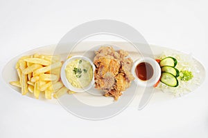 Deep-Fried Chicken chicharr n de pollo , Fried chicken nuggets, French fries and vegetables with chili sauce. photo
