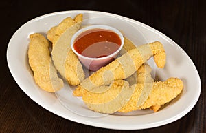 Deep Fried Chicken Fingers with Marinara Tomato Sauce on a Plate