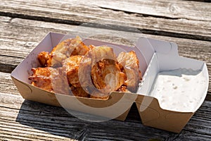 Deep fried cod fish in pieces served outdoor with tartar sauce