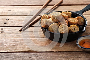 Deep-fried crab Meat Rolls in a Black pan
