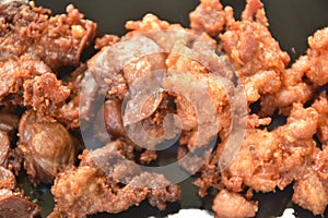 Deep fried crispy salty chicken meat and gizzard on plate