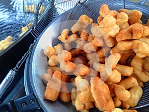 Deep-fried dough stick fried in hot oil For eating as a snack.