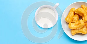 Deep-fried dough stick and Soybean milk on blue background