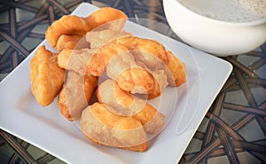 Deep fried dough stick or Youtiao, Chinese fried breadstick, serving on white plate. Popular food for Thai breakfast