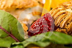 Deep-fried doughnuts filled with coconut custard cream on white baking paper on light background photo