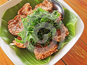 deep fried fish cake with fried holy basil