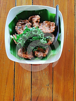 deep fried fish cake with fried holy basil