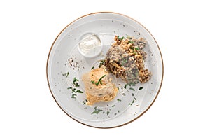 Deep fried fish fillet in batter with buckwheat with mushroom and white sauce isolated on white background