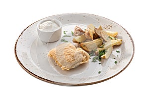 Deep fried fish fillet in batter with potato wedges and white sauce isolated on white background