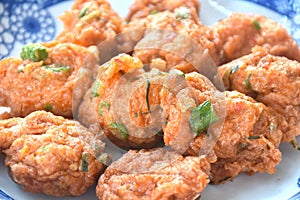 deep fried fish patty on plate with slice cucumber dipping sweet chili sauce