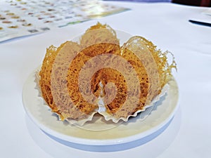 Deep-fried golden crispy hot taro dumplings in Yum Cha Chinese restaruant on white dish