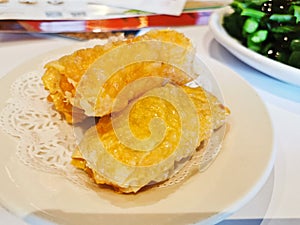 Deep-fried golden crispy hot tofu skin wrapped around prawn meat dumpling in Yum Cha Chinese restaurant