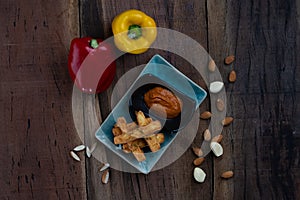 Deep-fried haloumi cheese with panko crust and romesco sauce photo