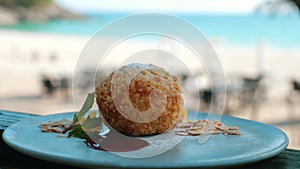 Deep-fried ice cream on white plate with strawberry jam