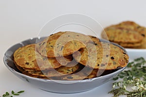 Deep fried Indian flat bread made of whole wheat flour, cooked lentils and moringa leaves and spices