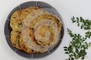 Deep fried Indian flat bread made of whole wheat flour, cooked lentils and moringa leaves and spices
