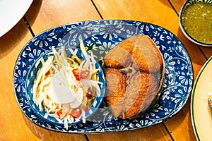 Deep fried king mackerel with spicy mango salad - Thai food