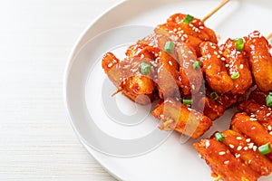 Deep fried Korean rice cake Tteokbokki skewered with spicy sauce