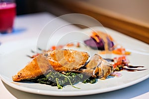 Deep fried mackerel steak with mashed purple sweet potatoes serve on white plate - organic food concept.