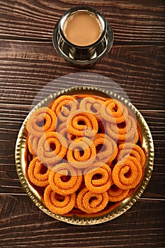 Deep  fried murukku or chakli. served in brass plate.