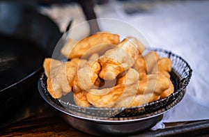Deep-fried Patongo is a fried Chinese food served with coffee in a market in Yaowarat, Bangkok