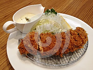 Deep-fried pork served with slice cabbage, lemon and mayonnaise or tartar sauce in restaurant, Pork cutlet set, Japanese Tonkatsu