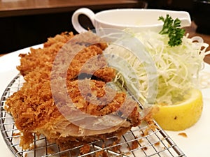 Deep-fried pork served with slice cabbage, lemon and mayonnaise or tartar sauce in restaurant, Pork cutlet set, Japanese Tonkatsu