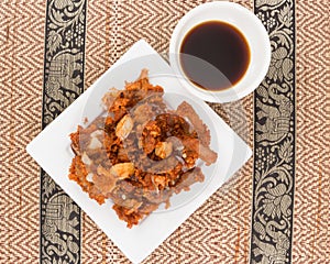 Deep fried pork tendons with black sauce