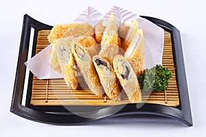 Deep fried Shishamo and crab stick on wooden dish isolated on wh