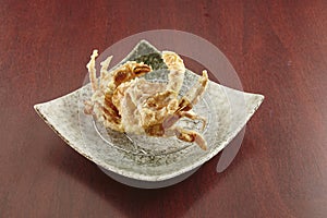 deep fried Soft Shell Crab served in a dish isolated on wooden table side view of singapore food