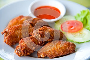 Deep fried spicy chicken wing with sauce photo