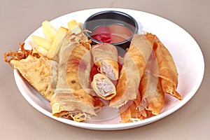 Deep fried spring roll,and frence fries sreved with tomato souce and chili sauce.