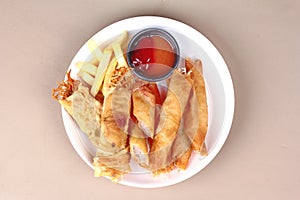 Deep fried spring roll,and frence fries sreved with tomato souce and chili sauce.