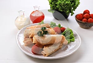 Deep Fried Spring Rolls, Popular as Lumpia or Popia. Served on White  Plate, White table with Spicy Sauce and Mayonaise.