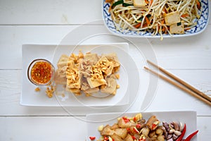 Deep fried tofu is cut into square balls on plate