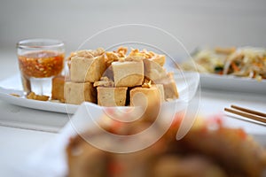 Deep fried tofu is cut into square balls on plate