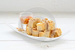 Deep fried tofu is cut into square balls on plate