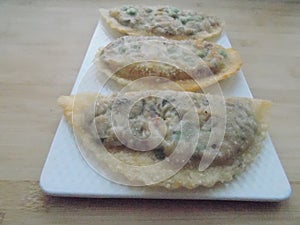 deep-fried traditional Asian pies with fish and vegetables