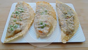 Deep-fried traditional Asian pies with fish and vegetables.