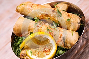Deep Fried Vegetable spring roll with lime served in dish isolated on background top view of hot mezza photo