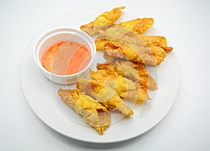 Deep Fried Won ton on white plate with dip source