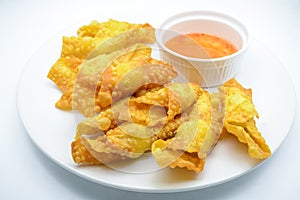 Deep Fried Won ton on white plate with dip source