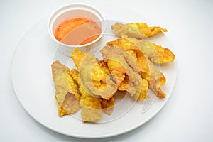Deep Fried Won ton on white plate with dip source