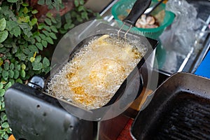 Deep frying French Fries in deep fryer