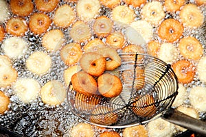 Deep frying medu vada in the pan. Medu Vada is a savoury snack from South India, very common street food in the India. photo